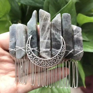 Detailed view of handmade crystal hair comb with raw labradortite and silver moon detail