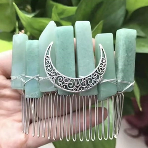 Detail showing natural raw crystal hair comb with a silver moon charm and wire-wrapped stones