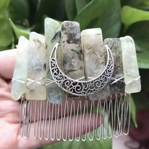 Detail of handmade natural crystal hair comb featuring crescent moon on vintage silver teeth