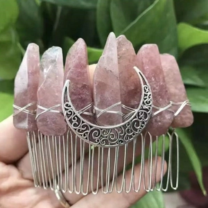 Macro detail of handmade pink crystal hair comb with silver crescent moon and wire wrapping