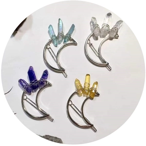 Handmade moon hair clips with raw crystal pillars in blue, clear, purple, and amber colors