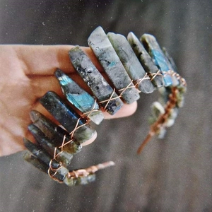 Macro detail of handmade moonstone bridal crown with copper wire wrapping and labradors