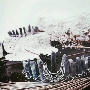 Detailed view of raw grey labradorite moon crown with silver wire wrap and gothic crystal texture