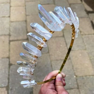 Detail of handcrafted gold wire wrapped iridescent white crystal crown with bohemian style