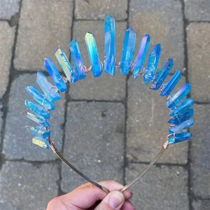 Macro detail of aurora blue quartz crystals hand-wrapped with gold wire on bridal crown