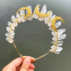Detailed view of handmade crystal crown with moon charms and raw quartz stones