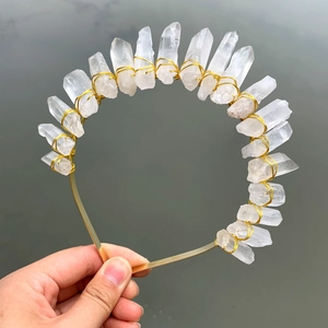 Detail of natural white crystal quartz crown showing handmade gold wire wrapping textures