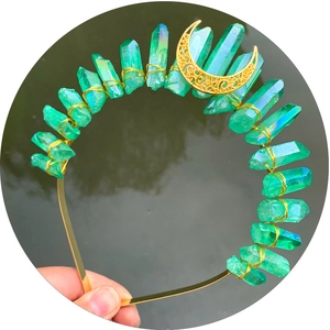 Handmade green crystal moon crown headband with gold wire wrapping on a dark water background