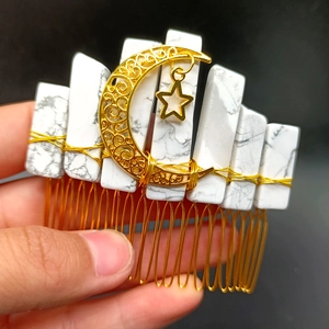 Detail of handmade crystal hair comb with celestial gold moon and star charms