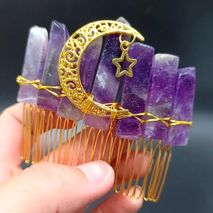 Macro detail of natural purple crystal hair comb with gold moon and star wire-wrapped charms