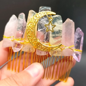 Detail of handmade crystal hair comb featuring gold moon and star pendants with raw stones