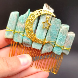 Detailed macro view of handmade moon and star hair comb with natural amazonite stones
