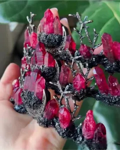 Close-up of gothic crown featuring dark bronze branches and raw red crystal stones