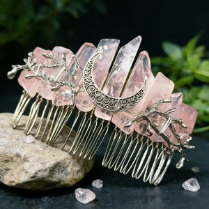 Rose quartz hair comb with silver crescent moon and branch details on natural stone