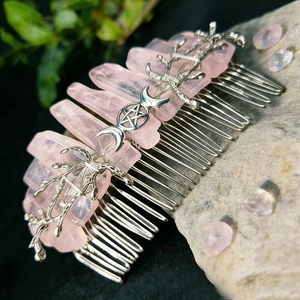 Macro detail of rose quartz hair comb with silver celestial branch and star symbols
