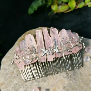 Handmade pink crystal hair comb with silver moon, star, and branch motifs on natural stone