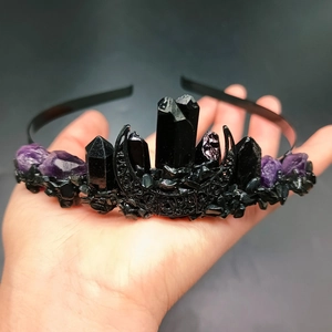 Detailed close-up of gothic crystal crown with black moon charm and raw amethysts