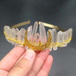 Detail of handmade bohemian gold moon crown featuring natural white crystal stones