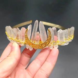 Detailed close-up of a handmade bohemian white crystal moon crown with golden moon ornament