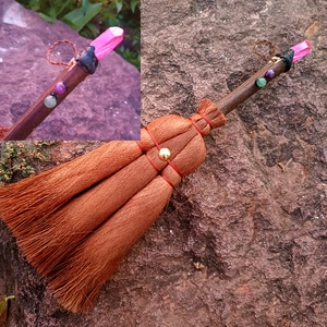 Detail of a handmade Wicca broom car charm with pink crystal point and gold bead