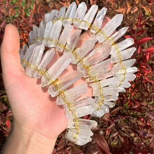 Detail of natural white crystal crown handcrafted with golden wire on metal headband