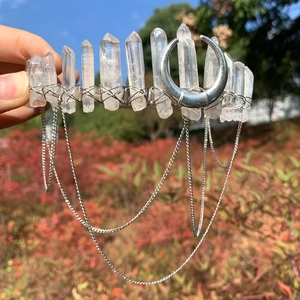 Detail view of natural crystal moon crown with dangling silver metal chains and wire wrap