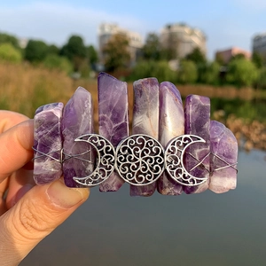 Detailed close-up of bohemian triple moon hair clip with natural purple amethyst crystals