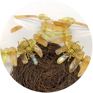 Luxury amber raw crystal headband with golden bees on natural twig nest display