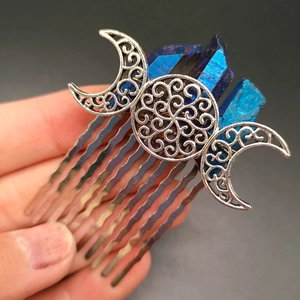 Detail of silver goddess hair comb with lunar symbols and purple crystal clusters