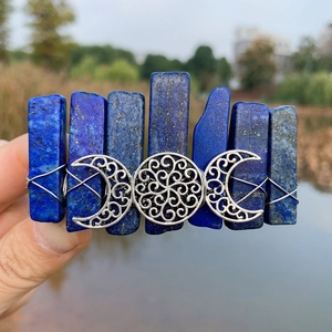 Detailed macro view of bohemian lapis lazuli hair clip with silver triple moon icon