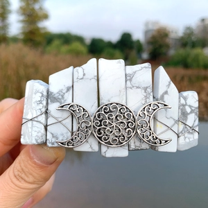 Detail of bohemian triple moon hair clip with white marbled stones and silver filigree