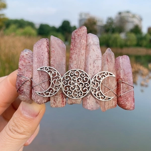Detail of pink strawberry crystal hair clip with silver triple moon goddess metal symbol