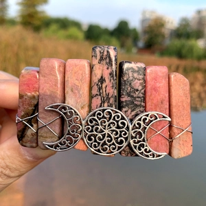 Detail of pink rhodonite stones and silver triple moon metalwork on bohemian hair clip