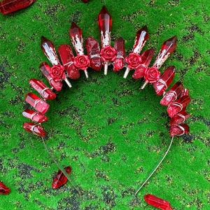 Handmade red crystal crown headband with metallic flower and moon details on moss