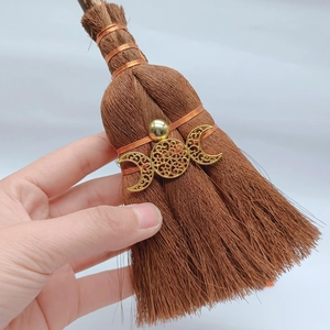 Detail of mini witch broom pendant with copper wire wrap and golden moon symbol