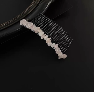Detail of pink crystal gravel stones wired onto a silver 20-tooth metal hair comb