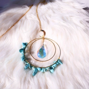 Dettaglio collana con anello dorato bohémien, pietre turchesi e ciondolo luna