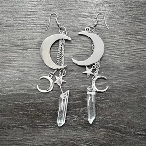 Bohemian triple moon star earrings with natural white crystal drops on grey wood background