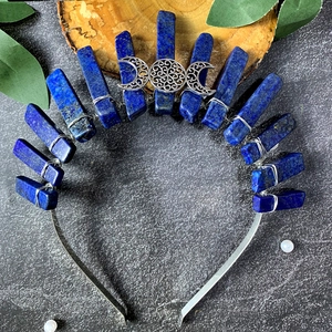 Detail of blue crystal stones and silver moon goddess motif on a bridal crown