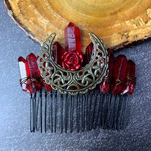 Detail of red crystal hair comb featuring a bronze moon and rose in gothic style