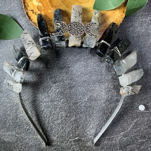 Macro detail of obsidian and quartz crystal crown with triple moon symbol detail