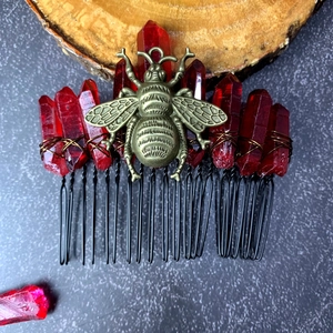 Detail of handmade deep red crystal hair comb with bronze bee motif and wire wrapping