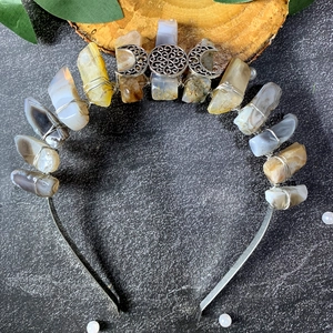 Detailed close-up of natural raw crystal crown with triple moon metal craft and silver wire