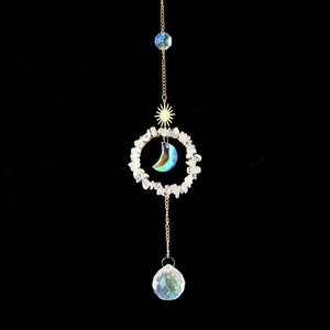 Golden suncatcher with natural crystal stones and a multifaceted crystal ball pendant