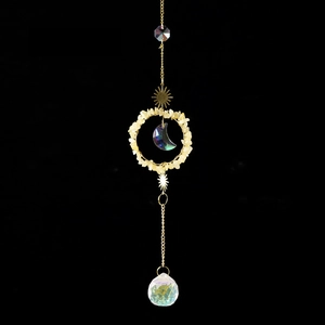 Detailed suncatcher with golden sun and moon elements with natural citrine crystals
