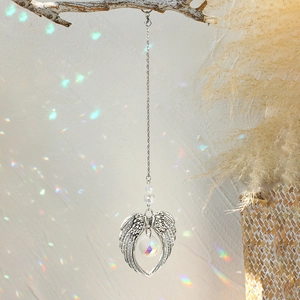 Bohemian crystal suncatcher with angel wings and crystal ball producing rainbow reflections