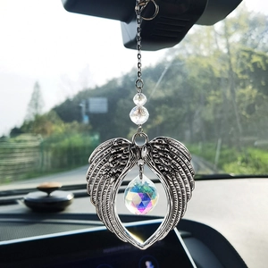 Detailed view of silver angel wings car charm with faceted colorful crystal prism