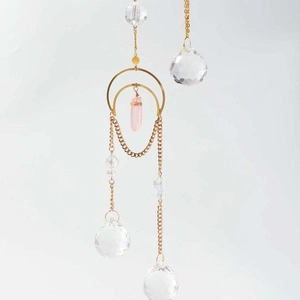 Nordic crystal suncatcher with natural rose quartz prism and golden metal crescent frame