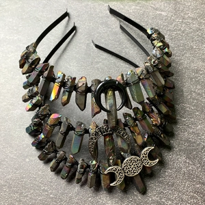Macro shot of iridescent crystal crowns with black wire wrapping and crescent moon charms