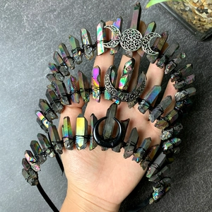 Close-up of iridescent natural crystal moon crowns with black wire and wicca charms